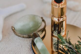 silver and black tube type vape beside silver spoon and silver spoon