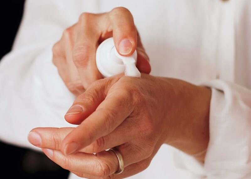 person holding white round ornament