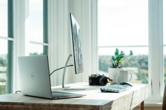 silver laptop on white table