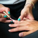 a person's hands with painted nails