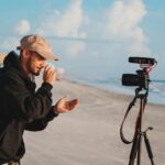 man in black jacket holding camera during daytime
