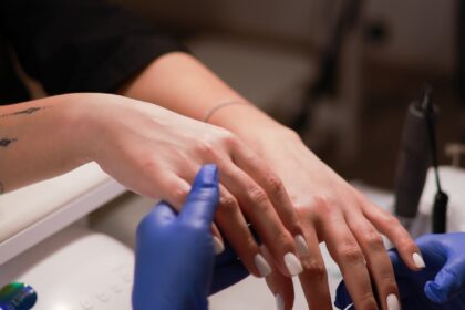 a woman getting her nails done at a salon