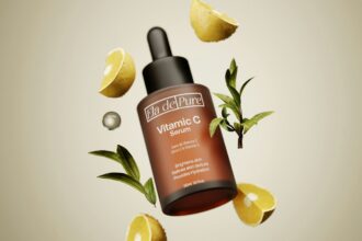 A bottle of vitamin c on top of lemon slices