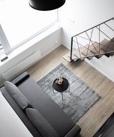 Aerial view of a stylish minimalist loft with modern furnishings and elegant decor.